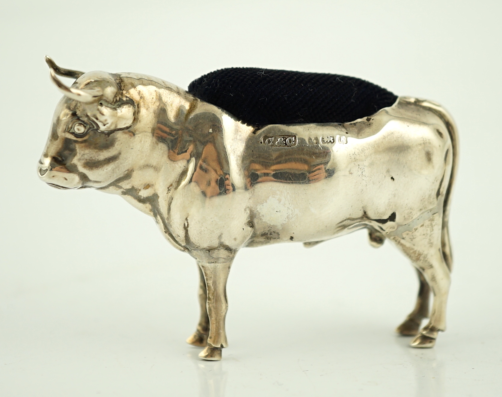 An Edwardian novelty silver pin cushion, modelled as a bull, Cohen & Charles